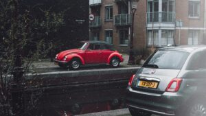 Red Volkswagen Beetle Parked on Sidewalk